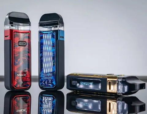 Electronic vaping devices in various colors, featuring the Smok Nord X 60W Pod Kit.