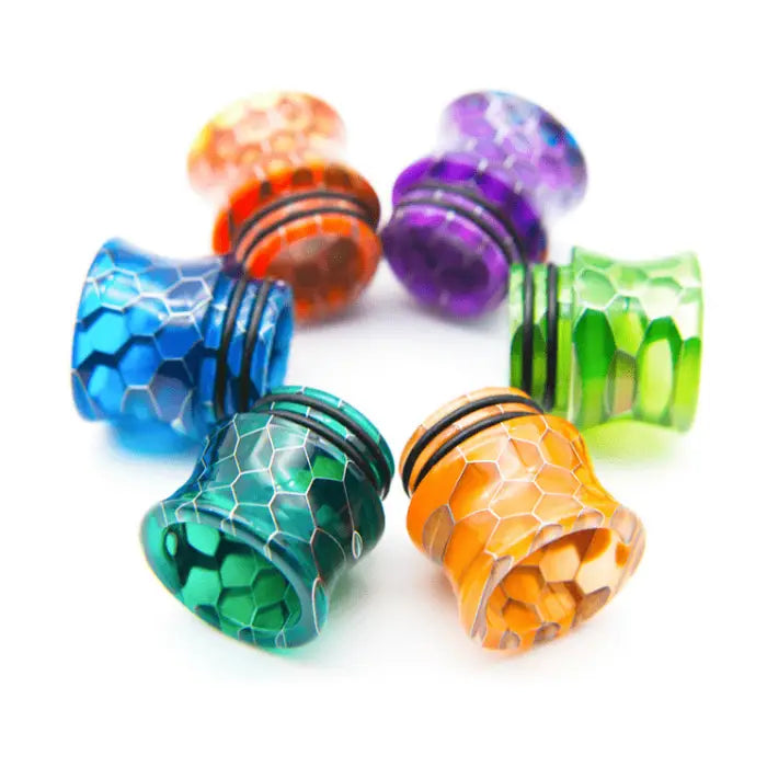 Colorful, honeycomb-patterned vape drip tips arranged in a circular formation.