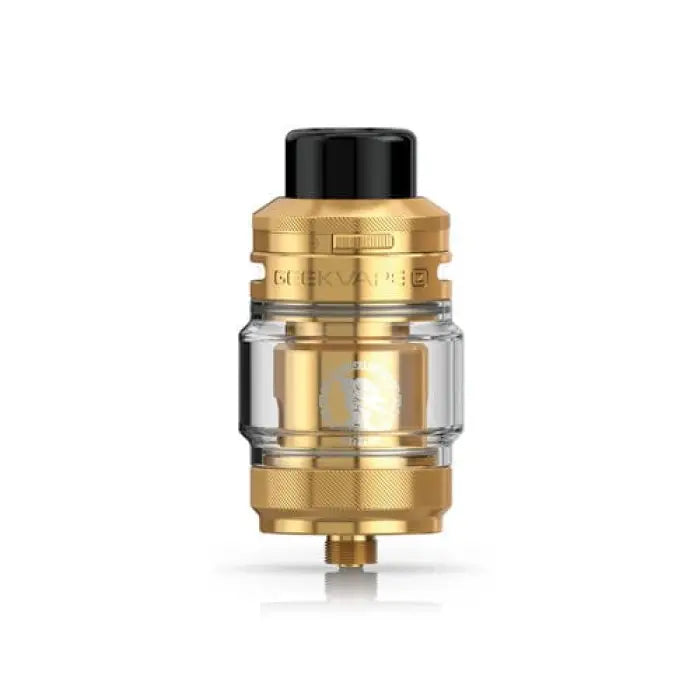 Gold-colored vaping tank or atomizer with a glass section and black top cap.