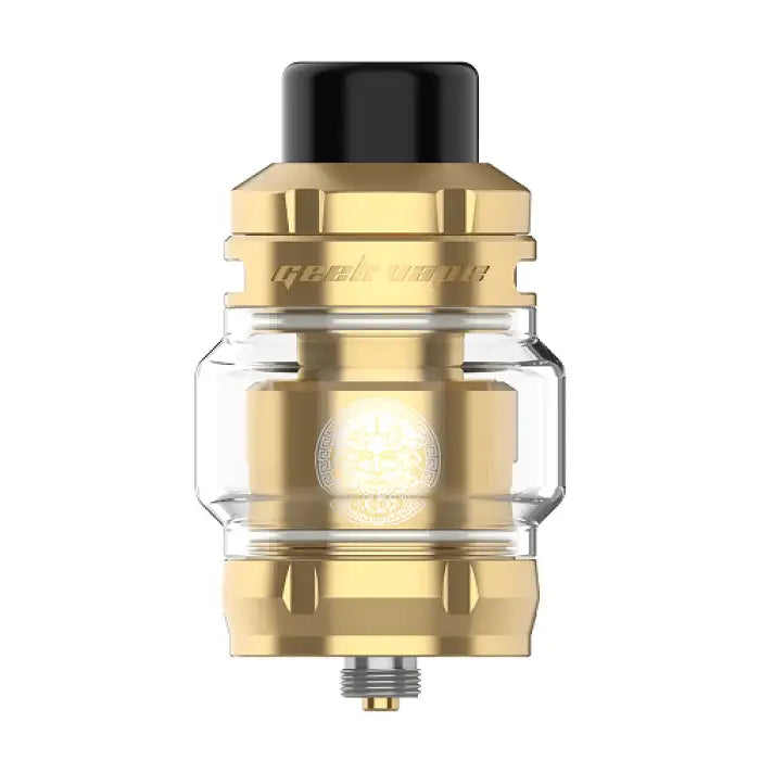 Gold-colored vaping tank or atomizer with a glass section and black drip tip.