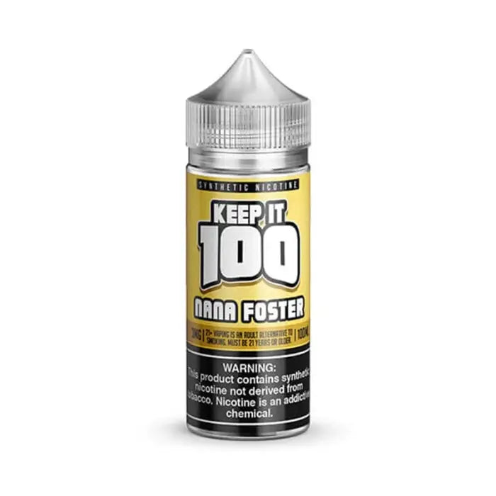 Bottle of e-liquid labeled ’Keep it 100 Nana Foster’ with a yellow label and silver cap.