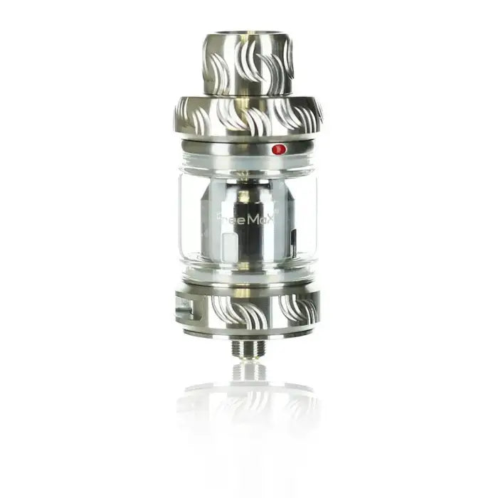 Metallic vaping tank or atomizer with a glass section and decorative patterns.