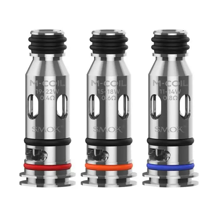 Three metal vaping coils or atomizer heads with colored rings at the base.