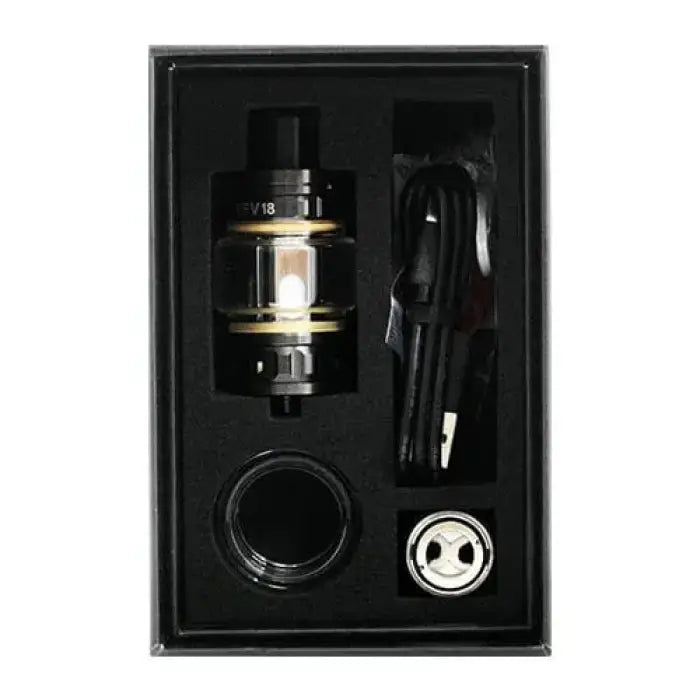 Vaping device kit with tank, coil, charging cable, and accessories in a display box.