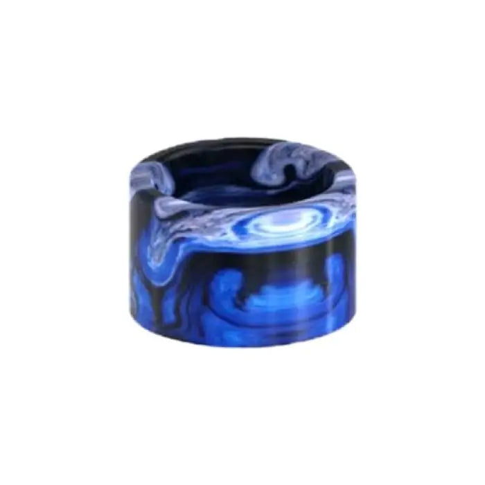 Cylindrical resin drip tip with swirling blue and white patterns.