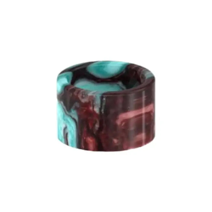 Cylindrical object with swirled teal and burgundy colors.