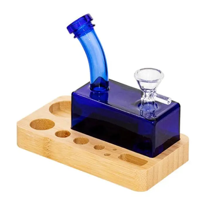 Blue glass water pipe with a wooden base containing multiple circular holes.