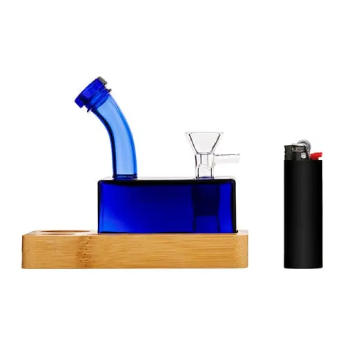 Blue glass water pipe with a curved neck sitting on a wooden base.