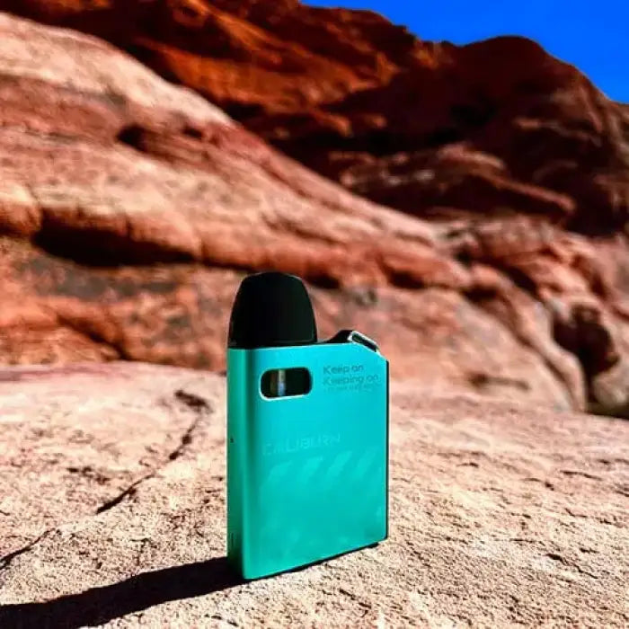 Teal-colored electronic vaping device or e-cigarette.